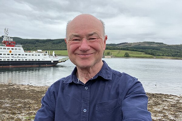 Alan at the Kyles of Bute with ferry in the background